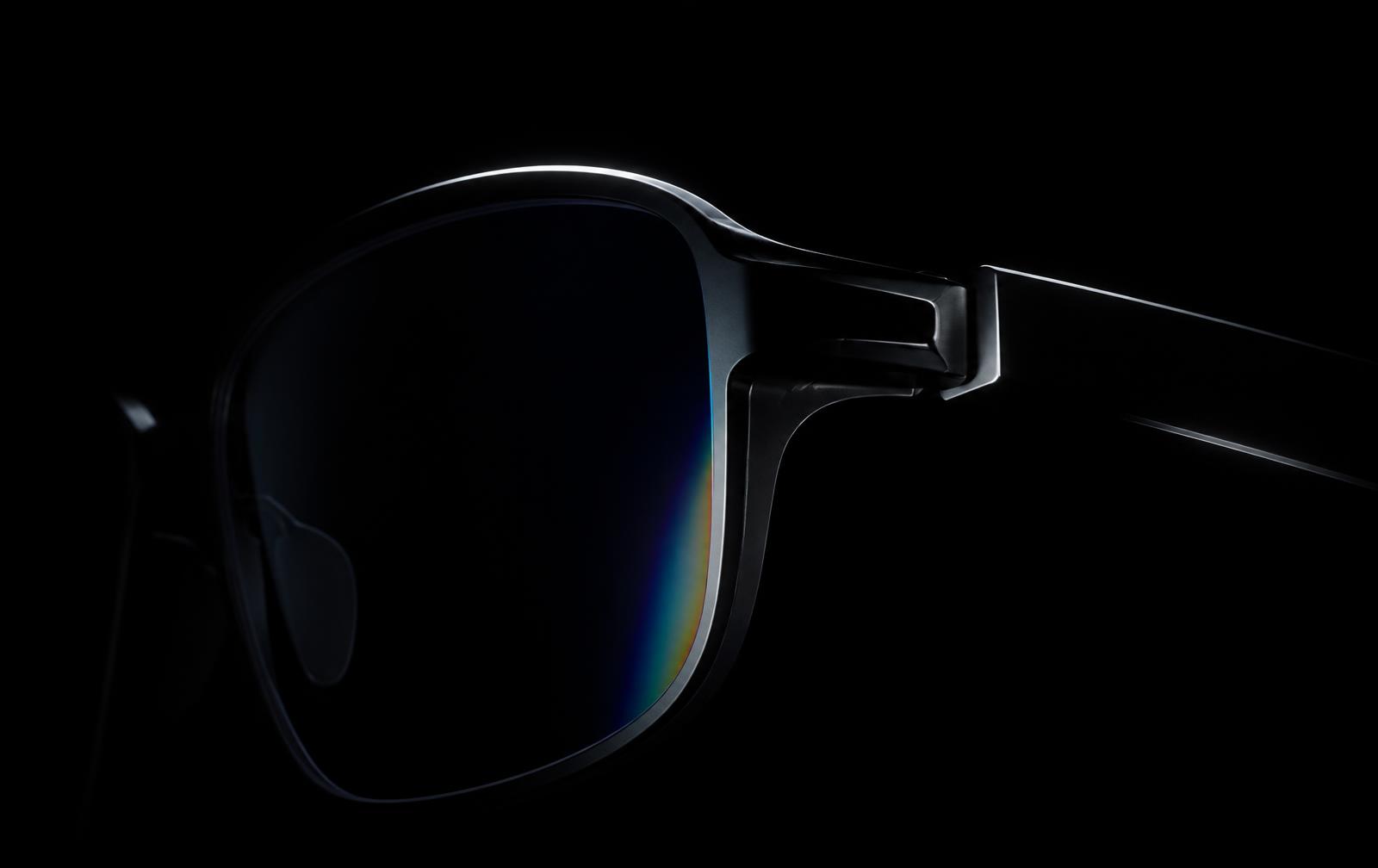 Smoked optical glass and black titanium eyewear contour traced by white light